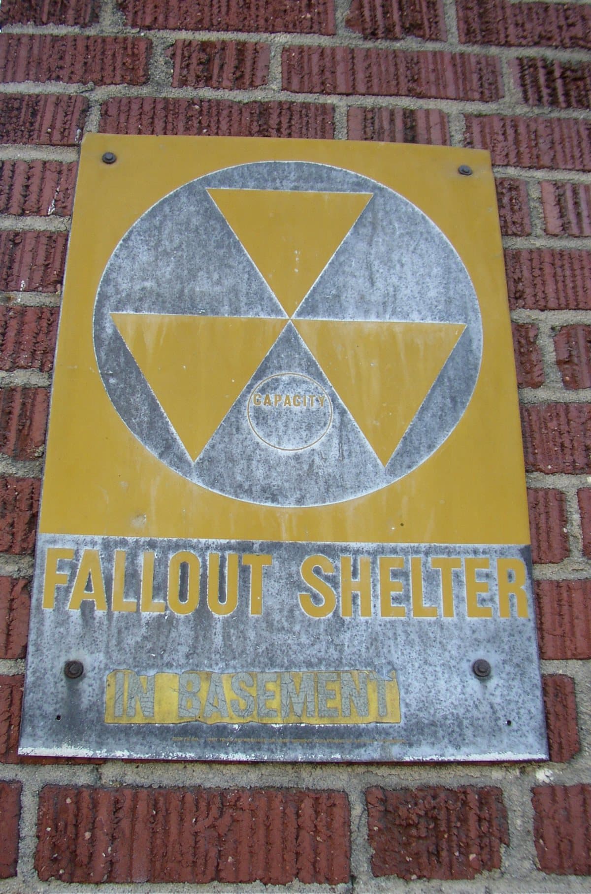 Civil defense sign emphasizing shelter decisions when judging how far from nuclear blast is safe