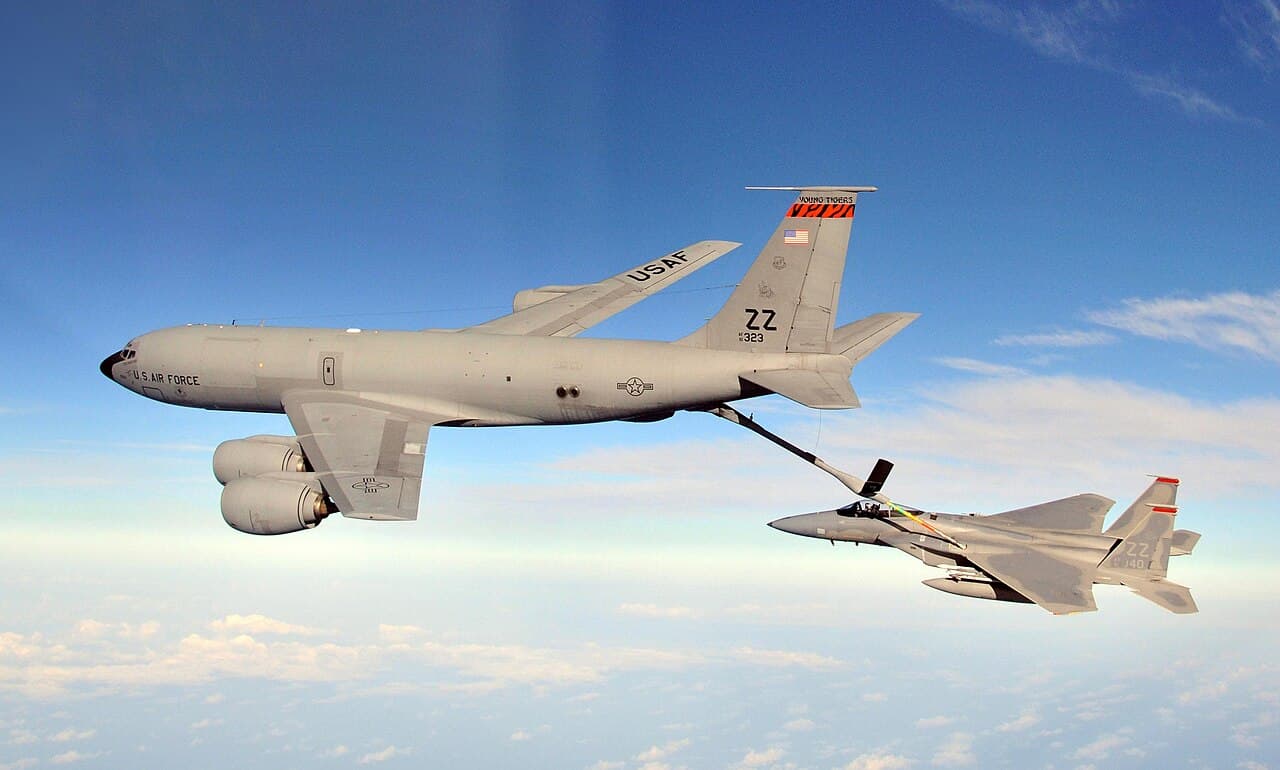 A U.S. Air Force KC-135R Stratotanker refuels an F-15C Eagle in flight, illustrating the aerial refueling operations critical to sustaining Operation Epic Fury